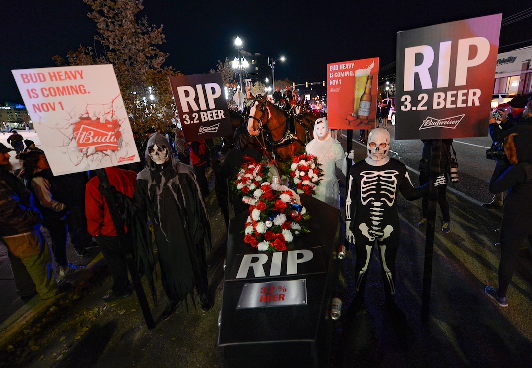 (Francisco Kjolseth  |  The Salt Lake Tribune)  Budweiser’s iconic Clydesdales make a special trip to Utah to celebrate the changing beer laws in the state, joined by a “ghoulish group of pallbearers,” on Wed. Oct. 30, 2019, for a funeral procession for Utah’s last remaining 3.2 percent beer, on their way to Bar X, Beer Bar and Johnny’s on 200 South in Salt Lake City, as the state prepares to start selling 5 percent alcohol-by-volume in grocery and convenience stores starting Friday.