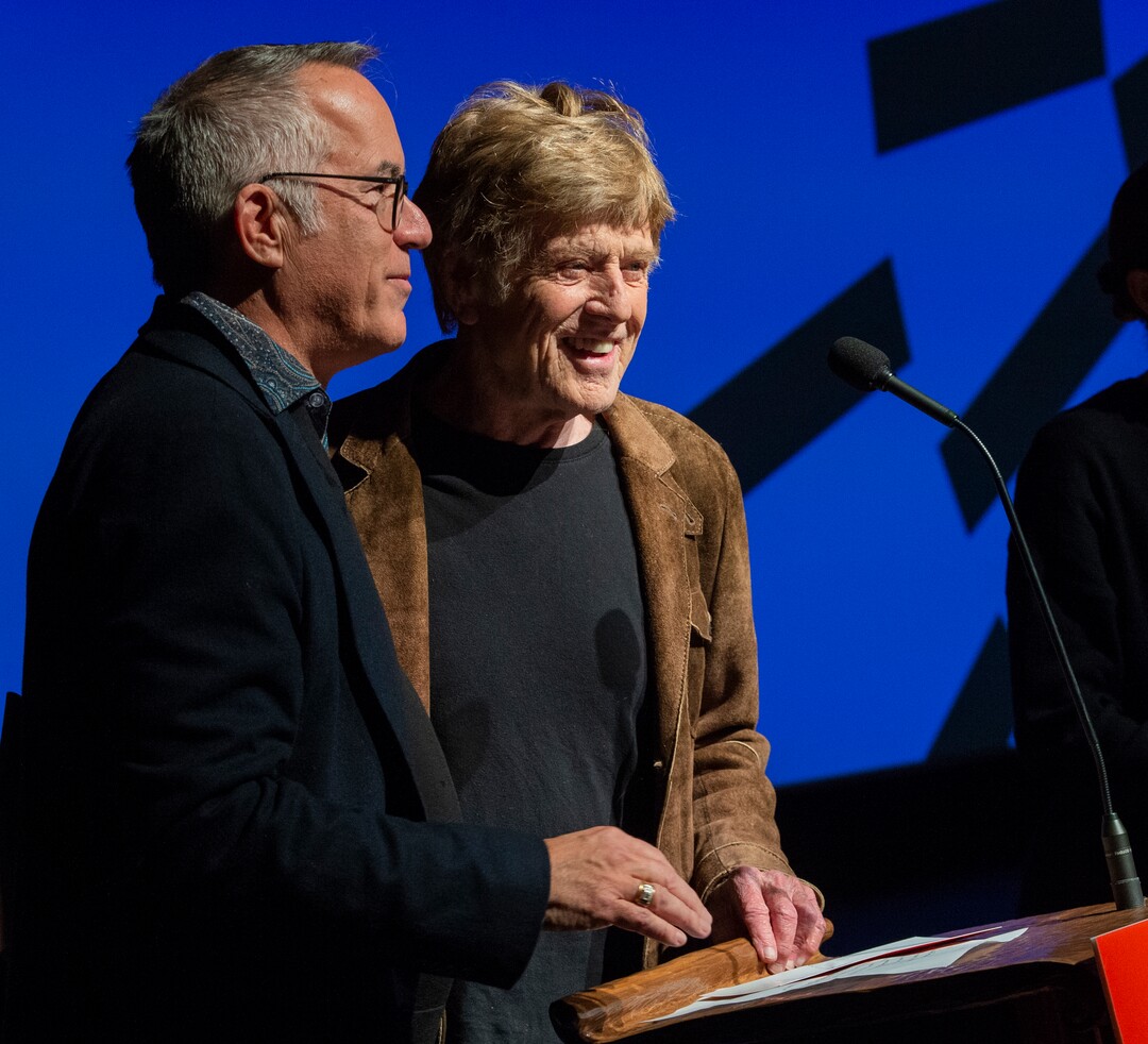 (Rick Egan  |  The Salt Lake Tribune)     Sundance Film Festival director John Cooper and Founder Robert Redford, welcome the crowd to Opening night film of the 2020 Sundance Film Festival, "Crip Camp", at the Eccles Theatre in Park City, Thursday, Jan. 23, 2020.
