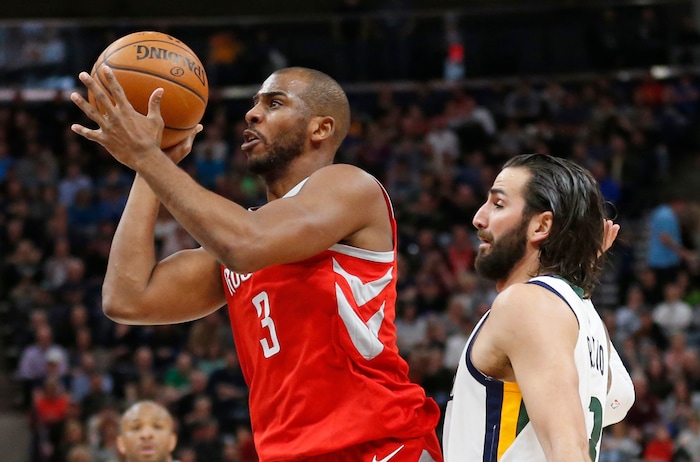 Houston Rockets guard Chris Paul (3) shoots as Utah Jazz guard Ricky Rubio, right, defends in the first half during an NBA basketball game, Monday, Feb. 26, 2018, in Salt Lake City. (AP Photo/Rick Bowmer)