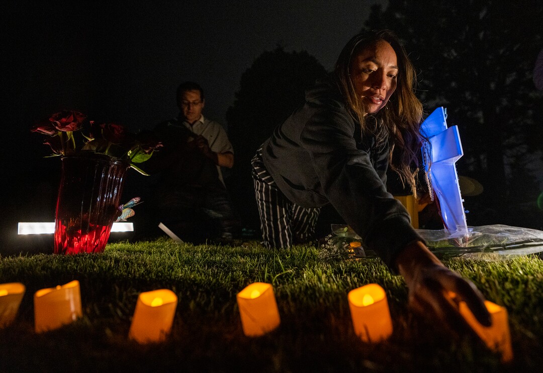 (Rick Egan | The Salt Lake Tribune) Karina the sister of Bernardo Palacios-Carbajal places candles on Bernardo's grave at the Salt Lake City Cemetery, after the "Long Live Loske" gathering at Rose Park on Saturday, May 22, 2021. The family of Bernardo Palacios-Carbajal hosted a "1st Heavenly Anniversary" event to celebrate the life of their son and brother to mark the 1-year anniversary of his death on May 23, 2020 by Salt Lake City Police, who fired 34 shots, killing the 22-year-old man.