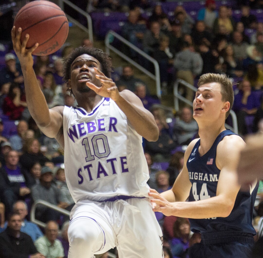 (Rick Egan  |  The Salt Lake Tribune)      Weber State Wildcats guard Jerrick Harding (10) takes the ball to the basket, as Brigham Young Cougars guard Connor Harding (44) looks on, in basketball action between Brigham Young Cougars and Weber State Wildcats, at the Dee Event Center in Ogden, Saturday, Dec. 1, 2018.