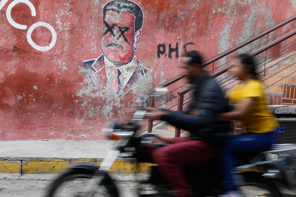 (Cristian Hernandez | The Associated Press) A motorcyclist rides past graffiti depicting former Venezuelan President Nicolas Maduro, who is facing trial in the United States after U.S. forces captured him, in Caracas, Venezuela, Sunday, Jan. 11, 2026.