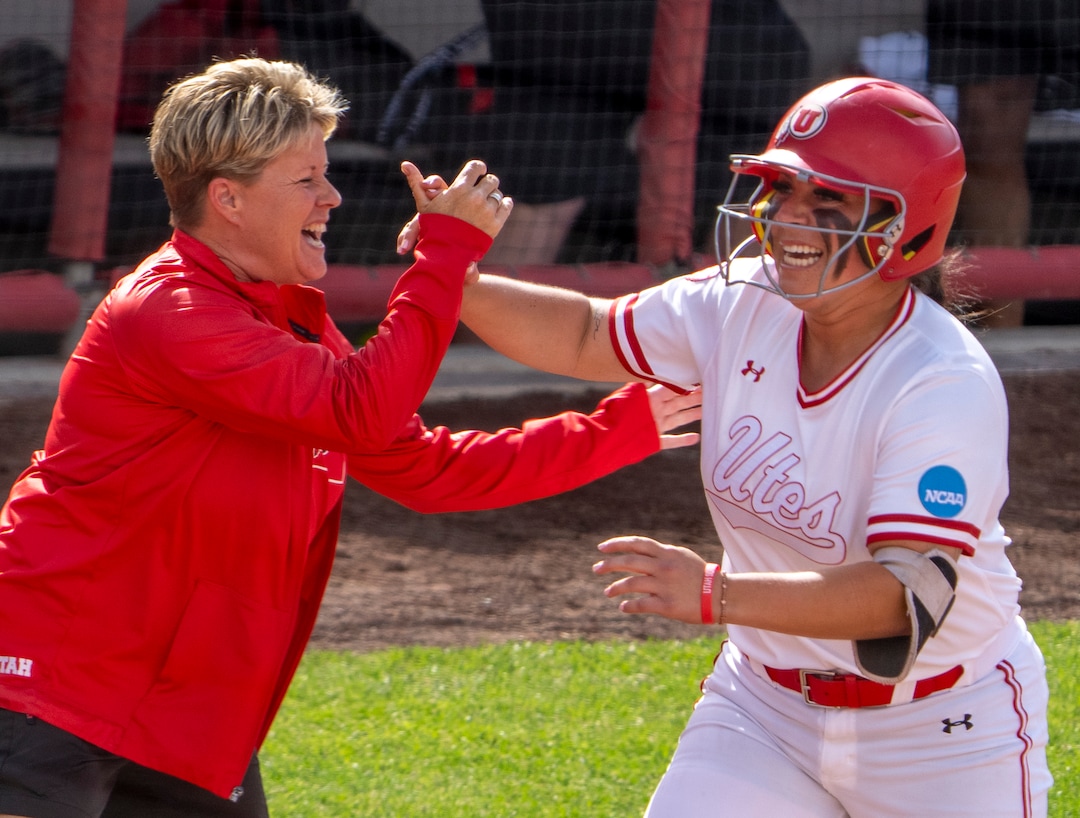 (Rick Egan | The Salt Lake Tribune)  Utah Head coach Amy Hogue celebrates with Julia Jimenez after she hit a grand slam home run, giving Utah a 7-1 lead, in NCAA Softball Super Regionals action between the Utah Utes and the San Diego State Aztecs, on Saturday, May 27, 2023.