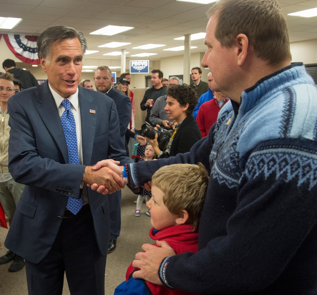 (Rick Egan  |  The Salt Lake Tribune)   Mitt Romney shakes hands with Danny Goode and his son Russell Goode, 7, at the Romney Headquarters, in Orem, as they wait for the polls to close, on election night, Tuesday, Nov. 6, 2018.