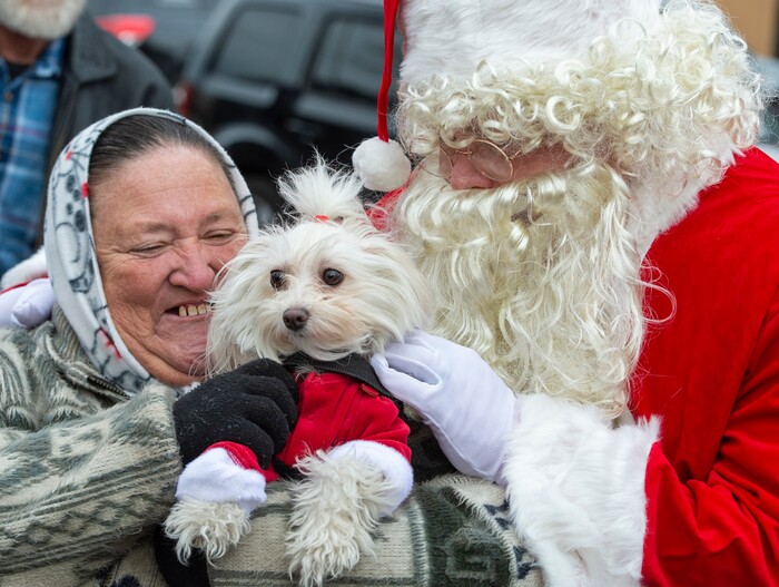 Dotty Antonio and her dog Carmela visit Santa Claus during the Street Dawg Crew Christmas outreach at Liberty Park Sunday.  The Street Dawg Crew supports the homeless and their pets every Sunday at Pioneer Park. Today besides passing out food and gift bags for humans and animals, they offered a photo opportunity with Santa. Sunday, Dec. 22, 2019.