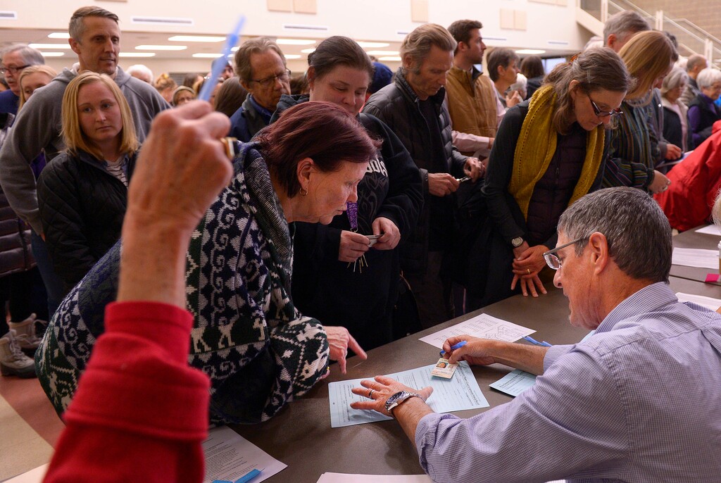 Leah Hogsten | The Salt Lake Tribune
Julie Jensen (center) wound up in the wrong line because of her cataracts, but eventually got her ballot. Lines and wait times were long at the Democratic caucus at Clayton Middle School as both registered party members and unaffiliated voters cast their ballots, Tuesday, March 22, 2016.