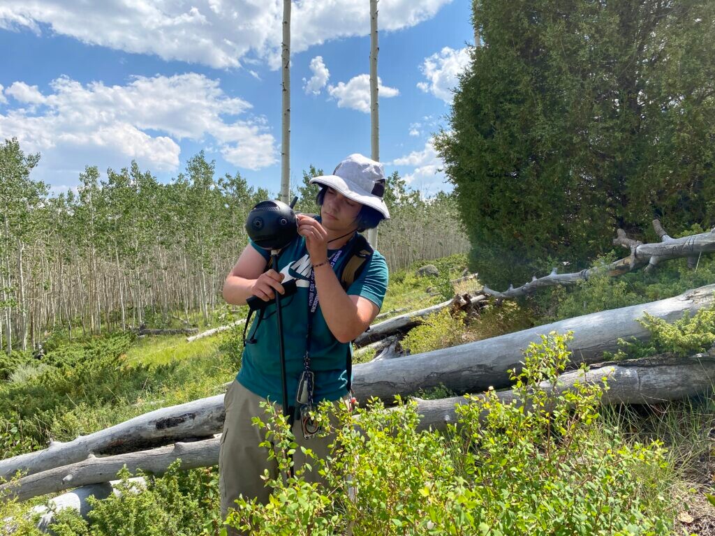 (Ammon Teare | St. George News) Wilson Thorpe, pictured here cleaning one of the lens of the 360 camera, traveled thousands of miles from his native New York to help with the survey, Fishlake, Utah, Aug. 5, 2021.