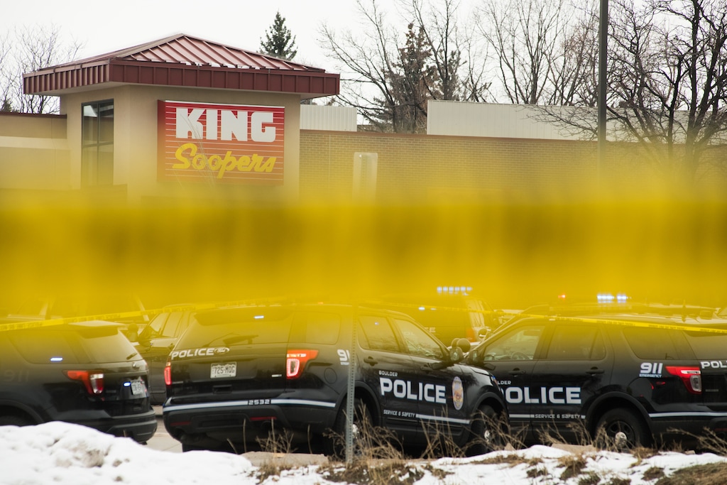 (Theo Stroomer | The New York Times) Police vehicles in the parking lot of the Boulder King Soopers grocery store after a shooting that killed multiple people in Boulder, Colo., on Monday, March 22, 2021.
