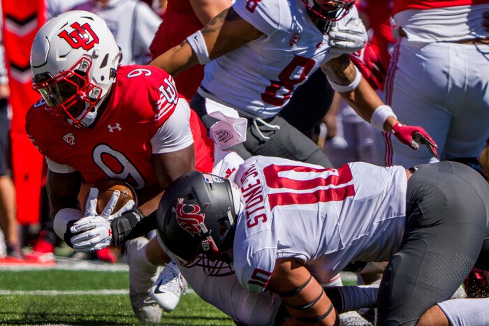 (Trent Nelson  |  The Salt Lake Tribune) Utah Utes running back Tavion Thomas (9) is stopped by Washington State Cougars defensive end Ron Stone Jr. (10) as the University of Utah hosts Washington State, NCAA football in Salt Lake City on Saturday, Sept. 25, 2021.
