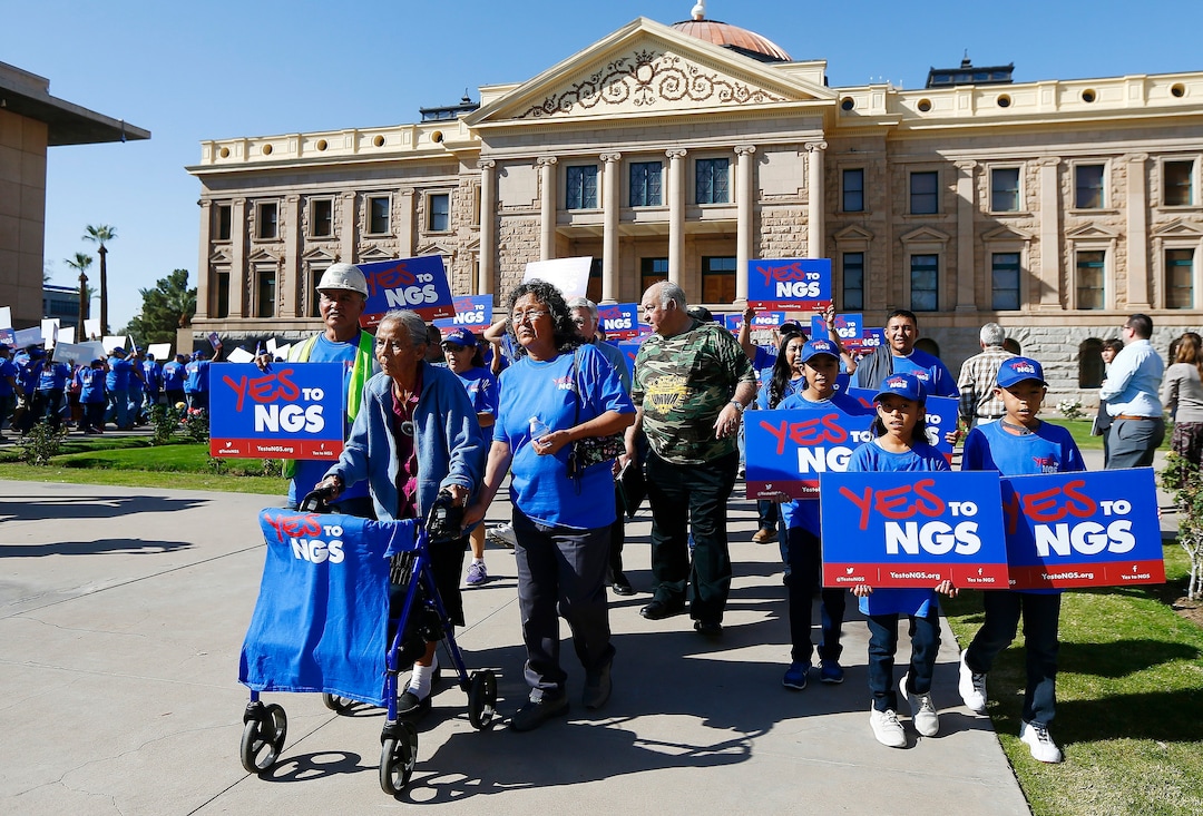 (Ross D. Franklin | The Associated Press) A coalition of groups march during a rally to build support for extending the life of the Navajo Generating Station power plant near the Arizona-Utah border, in front of the Arizona Capitol Tuesday, Feb. 6, 2018, in Phoenix.