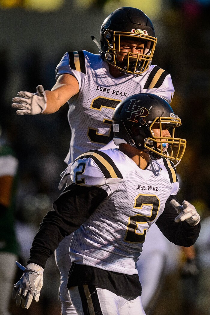 (Trent Nelson | The Salt Lake Tribune) Lone Peak's Brigham Trowbridge celebrates a first half touchdown as Kearns hosts Lone Peak, high school football, Thursday September 14, 2017. At rear is Lone Peak's Cody Collins.
