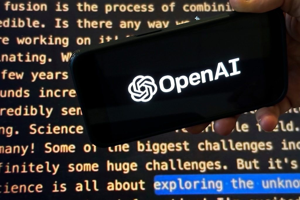 FILE - The OpenAI logo appears on a mobile phone in front of a screen showing a portion of the company website, Tuesday, Nov. 21, 2023, in New York. (AP Photo/Peter Morgan, File)