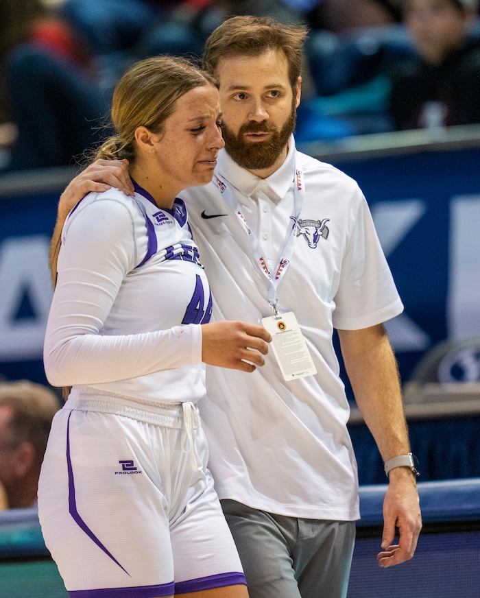 (Rick Egan | The Salt Lake Tribune) Coach Sean comforts Lehi forward, Jamisyn Heaton (44) as leaves the game after her 5th foul, in the girls 5A State Championship game between the Springville Red Devils and the Lehi Pioneers, at the Marriott Center in Provo, on Saturday, March 5, 2022. 
