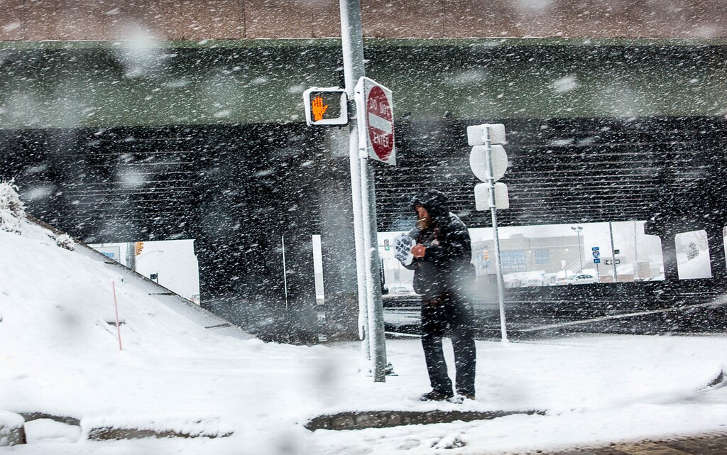 (Trent Nelson | The Salt Lake Tribune) A panhandler out in a snowstorm in Salt Lake City, Tuesday March 3, 2015.