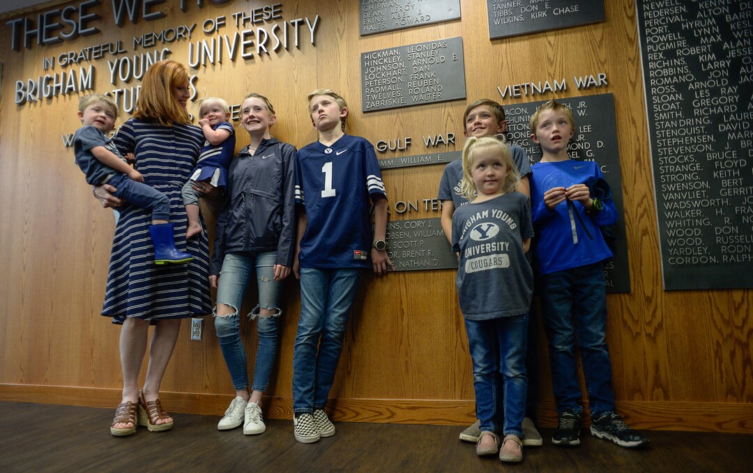 (Francisco Kjolseth  |  The Salt Lake Tribune)  Jennie Taylor is joined by her seven children as they gather for family photographs against the Student Center Reflection Room Memorial Wall as Brigham Young University honors the life and legacy of Major Brent Taylor who was killed in Afghanistan in 2018. The former mayor of North Ogden and a BYU Army ROTC alumnus was honored by the BYU Army ROTC who added his name to the list of 211 who have died in service.