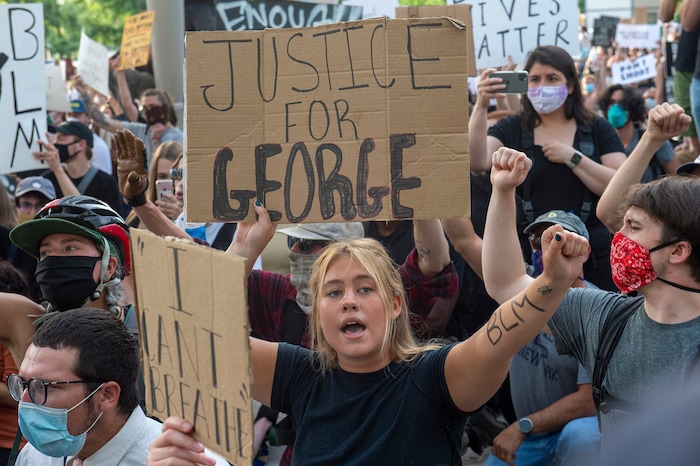 (Rick Egan  |  The Salt Lake Tribune)     Protesters urge the police to kneel with them at the Public Safety Building in Salt Lake City, Monday, June 1, 2020.