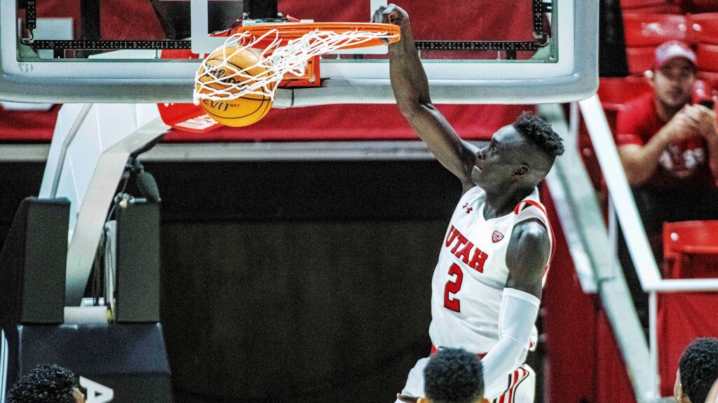 Utah guard Both Gach (2) dunks during the first half of an NCAA college basketball game against California, Sunday, Dec. 5, 2021, in Salt Lake City. (AP Photo/Isaac Hale)