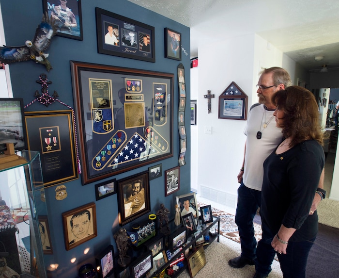 Steve Griffin / The Salt Lake Tribune

Karolyn and Sam Day look at a memorial for their son Jared Day in their Taylorsville, Utah home Monday August 1, 2016. On Aug. 6, 2011, Taliban fighters shot down a Chinook helicopter carrying 38 military personnel, including 31 Americans Ñ the largest loss of U.S. life in the Afghanistan campaign Ñ and two Utahns:  Jared Day and Blanding's Jason Workman.