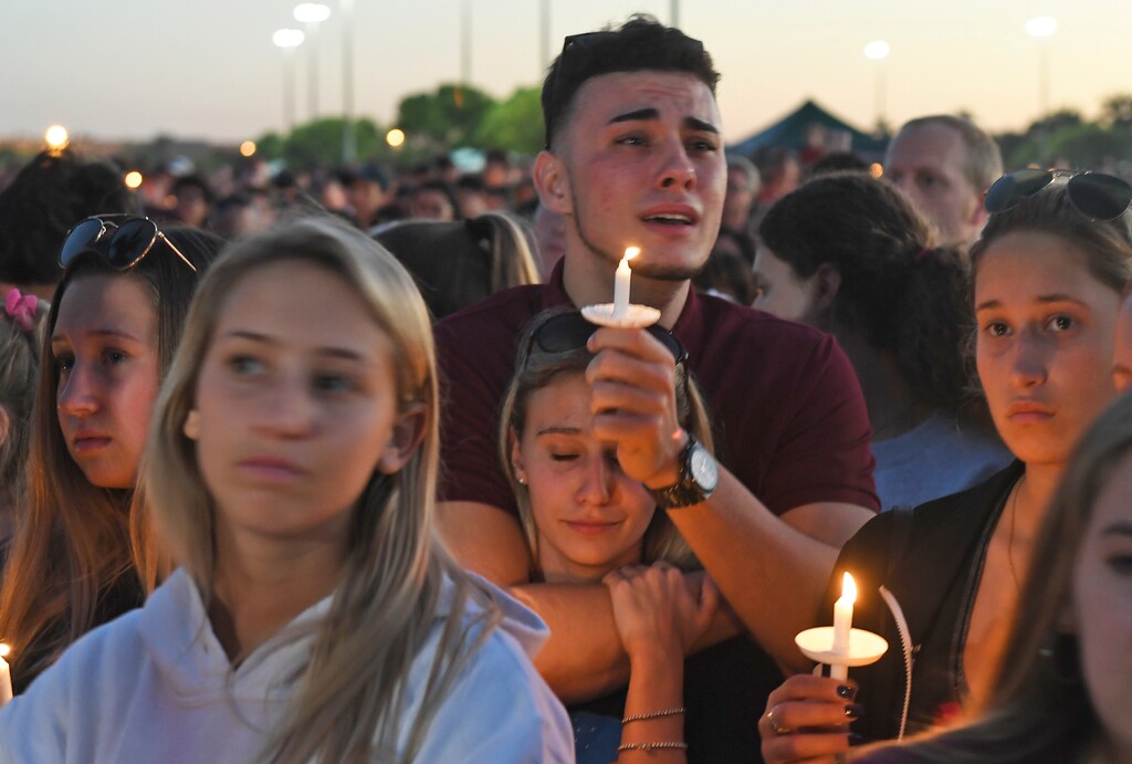 (Jim Rassol/South Florida Sun-Sentinel via AP) Mourners gather at a vigil for the victims of the shooting at Marjory Stoneman Douglas High School, Thusday, Feb. 15, 2018, in Parkland, Fla.