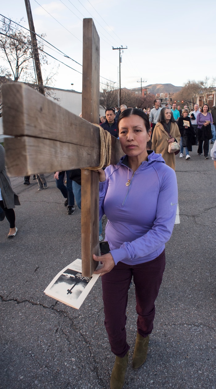 (Rick Egan  |  The Salt Lake Tribune)     Juana DeCasa carries the cross as 
Clergy and members of Christian denominations participate in the annual Good Friday procession through downtown Salt Lake City, Friday, March 30, 2018. The procession commemorating Christ's path to crucifixion has been a tradition of the Salt Lake Council of Churches since 1988. 


