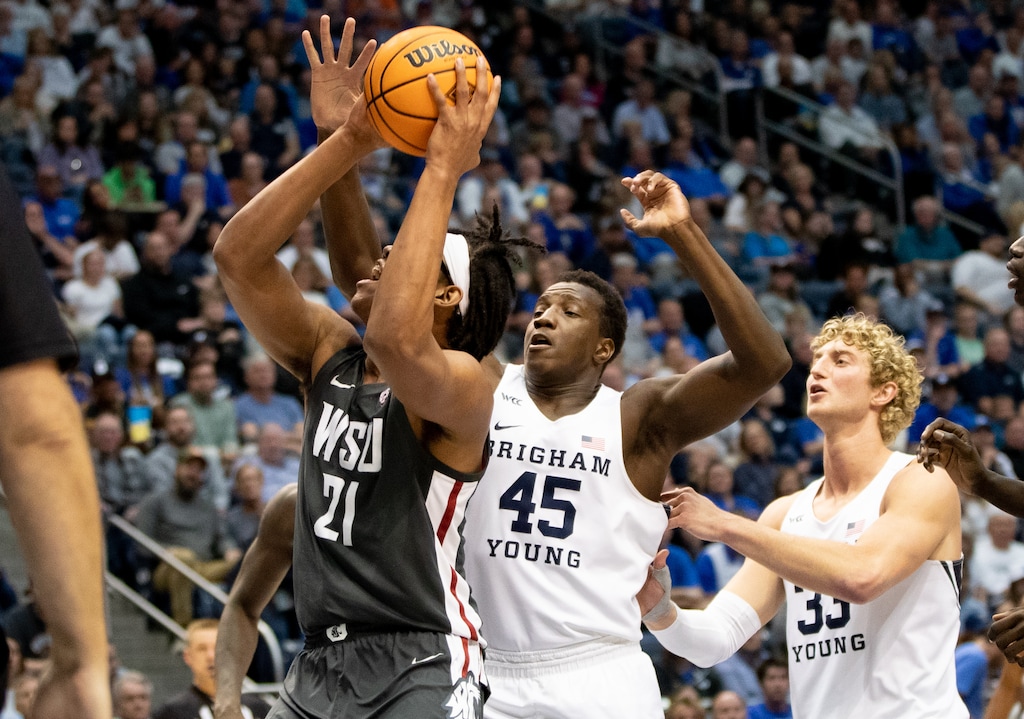 (Rachel Rydalch | The Salt Lake Tribune) Washington State Cougars center Dishon Jackson (21) and Brigham Young Cougars forward Fousseyni Traore (45) in NIT tournament action during the quarter finals game hosted at the Marriott Center in Provo, Wednesday, March 23, 2022.