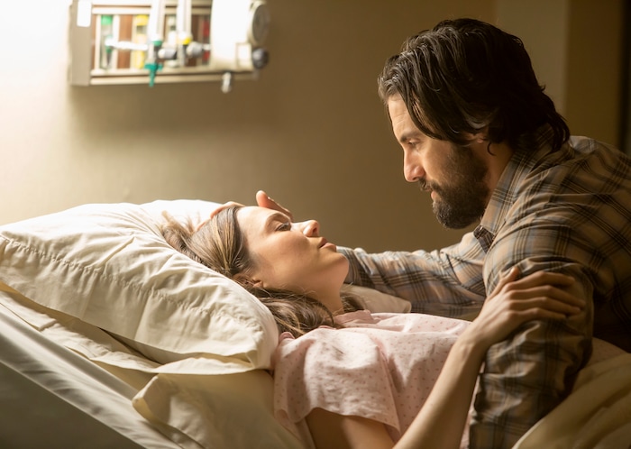 This image released by NBC shows Mandy Moore, left, and Milo Ventimiglia in a scene from "This Is Us." The season finale for the popular time-twisting family drama will air Tuesday at 9 p.m. EST on NBC. (Ron Batzdorff/NBC via AP)