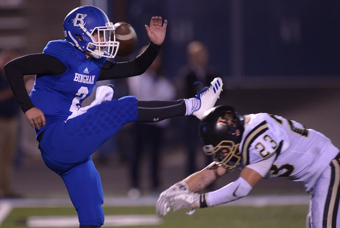 (Leah Hogsten | The Salt Lake Tribune) Bingham's Ryan Wood gets his punt knocked into Lone Peak's possession after Andrew Ostler blocks the kick. Bingham High School defeated Lone Peak High School, 28-10 during their game Friday, September 28, 2017 in South Jordan.