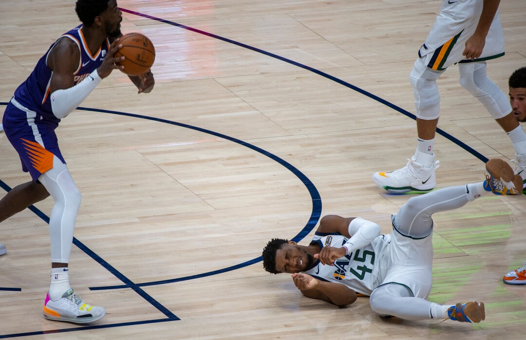(Rick Egan | The Salt Lake Tribune) Utah Jazz guard Donovan Mitchell (45) hits the ground after being fouled, in preseason NBA action between Utah Jazz and Phoenix Suns at Vivint SmartHome Area, on Saturday, Dec. 12, 2020.