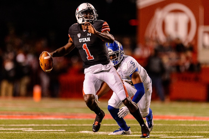(Trent Nelson | The Salt Lake Tribune) Utah Utes quarterback Tyler Huntley (1) avoids San Jose State Spartans safety Maurice McKnight (10) as the Utah Utes host the San Jose State Spartans, NCAA football at Rice-Eccles Stadium in Salt Lake City, Saturday September 16, 2017.