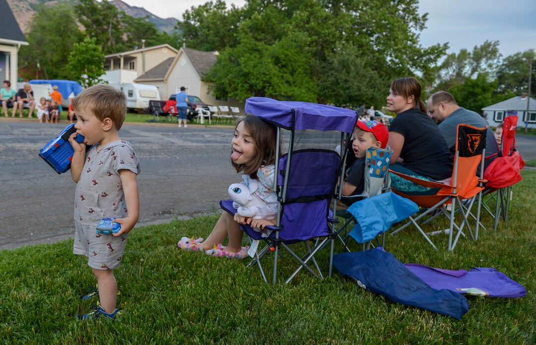 (Leah Hogsten  |  The Salt Lake Tribune) Westley Isaksen, left, sister Parker, brother Logan and parents wait for the procession in the yard of their new home they moved into two weeks ago on Custer Avenue. Friends and supporters lined the neighborhood of Officer Nate Lyday's childhood home on Custer Avenue in Ogden prior to the Memorial Procession and Community Vigil in honor of Lyday's life. The procession made its way through five other Ogden landmarks before ending at Lindquist Field.