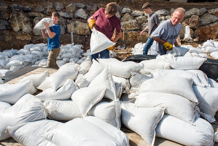 (Rick Egan  |  The Salt Lake Tribune)     Residents of Woodland Hills, make sand bag barricades, after being warned of possible flash floods with the coming rain, due to the recent fires in the area.  Monday, Oct. 1, 2018.


