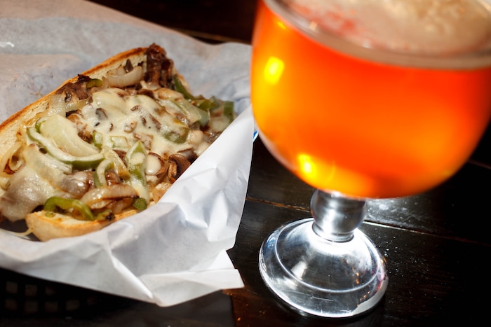 (Trent Nelson  |  Tribune File Photo)  The Philly Cheesesteak sandwich and a schooner of beer at Spedelli's in Salt Lake City.