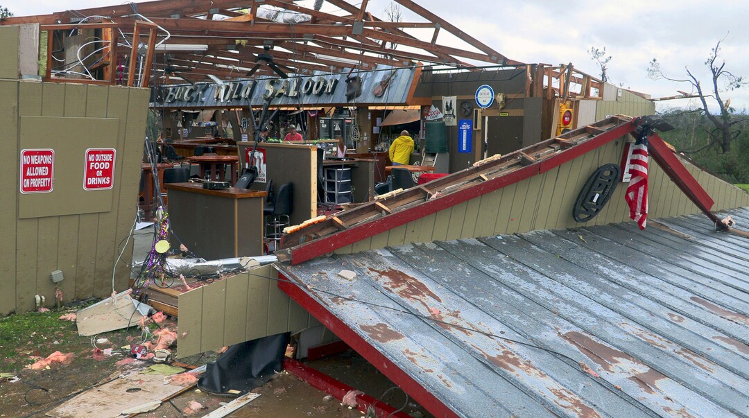 In this Sunday, March 3, 2019 photo, debris litters the Buck Wild Saloon, after it was heavily damaged by a tornado, in Smiths Station, Ala. (Mike Haskey/Ledger-Enquirer via AP)
