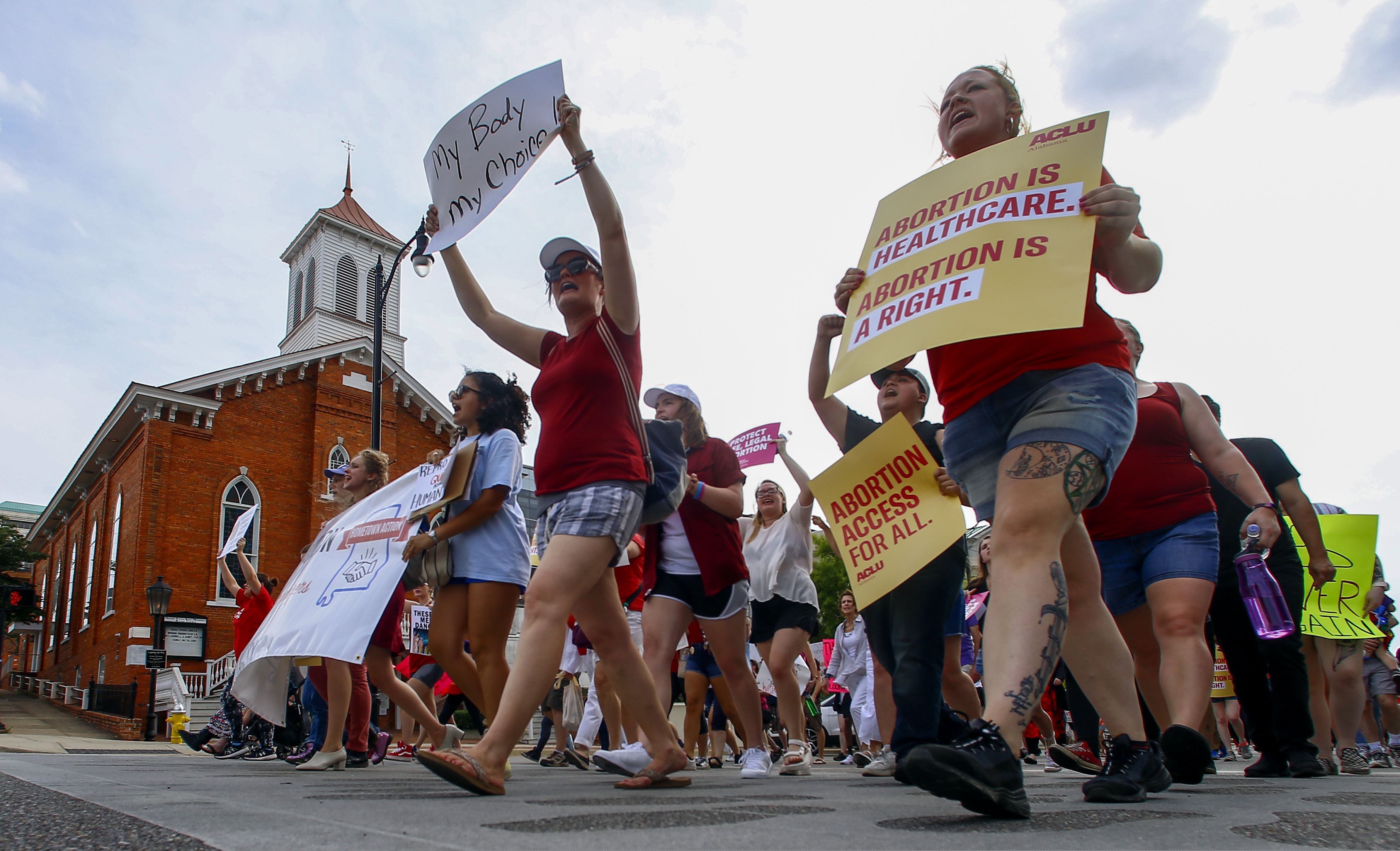 (Butch Dill | AP) Protesters for women's rights march past Dexter Avenue Baptist Church to the Alabama Capitol to protest a law passed last week making abortion a felony in nearly all cases with no exceptions for cases of rape or incest, Sunday, May 19, 2019, in Montgomery, Ala.