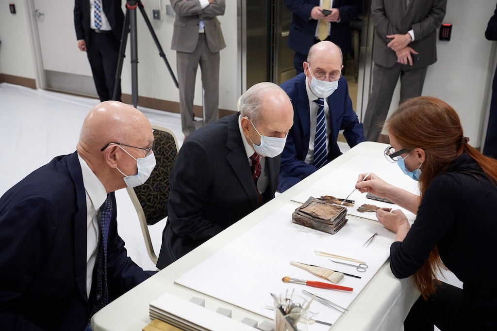 (Photo courtesy of The Church of Jesus Christ of Latter-day Saints) Emiline Twitchell, a conservator at the Church History Library, shows contents from the capstone of the Salt Lake Temple to the First Presidency on May 20, 2020.