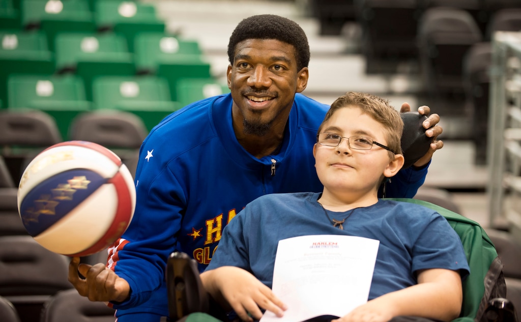 Lennie Mahler  |  The Salt Lake TribuneAustin Bennett, a 12-year-old with Duchenne muscular dystrophy, poses with Harlem Globetrotters player Buckets Blakes on Friday, Feb. 7, 2014, at EnergySolutions Arena. Bennett will meet and watch the Harlem Globetrotters play the World All-Stars on Monday, Feb. 10, as a "bucket list" item fulfilled by the Children and the Earth charity. 