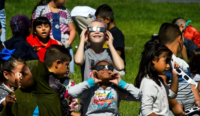 (Steve Griffin  |  The Salt Lake Tribune) Meadowlark Elementary School students watch The Great Eclipse during the Salt Lake School District's first day of the 2017-2018 school year. STEAM teacher-coordinator Wendi Laurence who formerly worked at NASA has been planning an event around the eclipse. All students had glasses to view the event and many had lunch outside at the Salt Lake City school Monday August 21, 2017.
