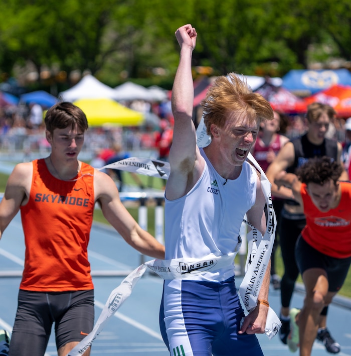 (Rick Egan | The Salt Lake Tribune)     Jaren Arnold Syracuse, celebrates as he crosses the fishline ahead of Jacob Smart, of Sky Ridge, in the 6A Boys 300 meter Hurdles, at the State High School Championships at BYU, on Saturday, May 21, 2022.
