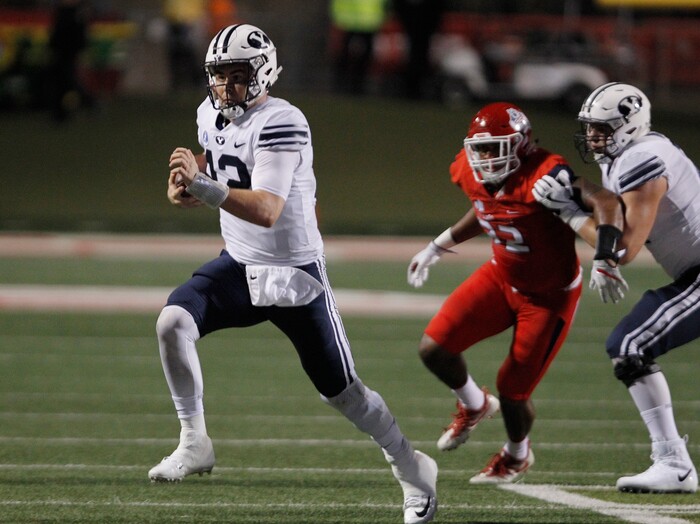 BYU's quaterback Tanner Mangum tries to outrun a Fresno State defender during the first half of an NCAA college football game in Fresno, Calif., Saturday, Nov. 4, 2017. (AP Photo/Gary Kazanjian)