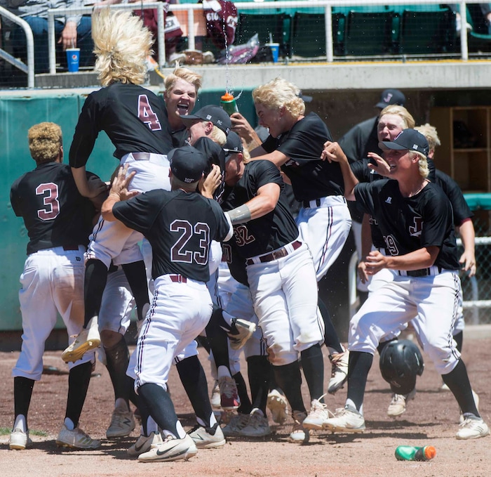 (Rick Egan  |  The Salt Lake Tribune)   Jordan High celebrates their 11-1 win over Olympus, for the 5A state baseball championship, at UVU in Orem, Friday, May 25, 2018.