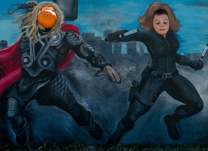 Leah Hogsten | The Salt Lake Tribune Kids pose and play around photo booth boards during the 2018 Fall Festival at Cross E Ranch in Salt Lake City, Thursday Oct. 18, 2018.