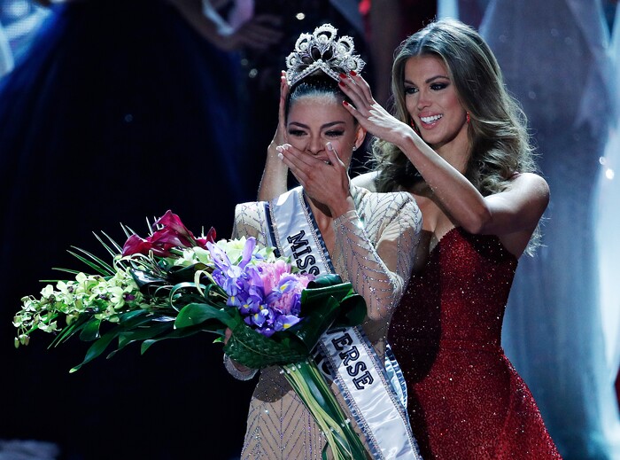 (John Locher | The Associated Press) Former Miss Universe Iris Mittenaere, right, crowns new Miss Universe Demi-Leigh Nel-Peters at the Miss Universe pageant Sunday, Nov. 26, 2017, in Las Vegas.