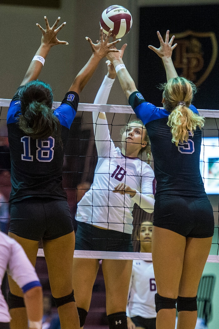 (Chris Detrick  |  The Salt Lake Tribune)    Lone Peak's Autumn SpaffordÊ(18) spikes the ball past Pleasant Grove's Heather Gneiting (5) and Pleasant Grove's Megan Sintay (18) during the volleyball match at Lone Peak High School Tuesday, September 5, 2017. 