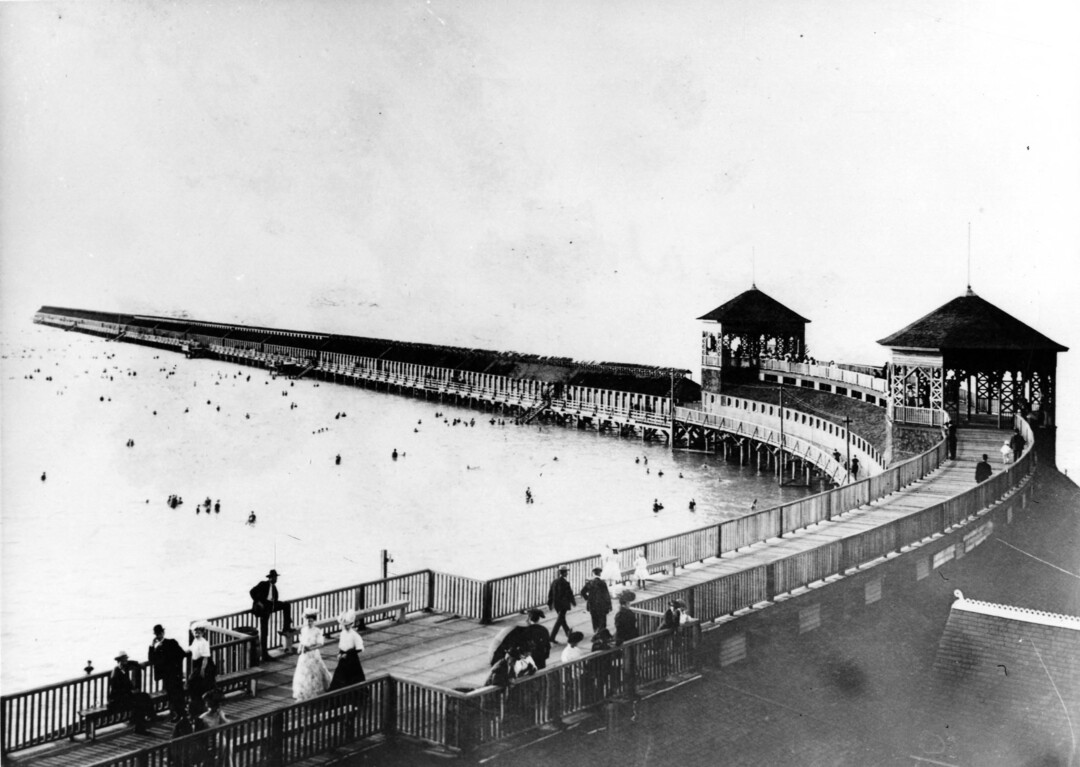 (Utah State Historical Society) A 1900s photograph of Saltair I, showing the walkway dressing rooms extending on either side of the resort out into the Great Salt Lake.