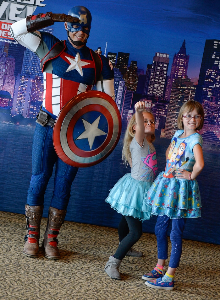 (Francisco Kjolseth  |  The Salt Lake Tribune)  Captain America poses for a photo with Addy Cook, 9, center, and her sister Hailey, 10, as Utah-based military families gather for the Salt Lake opening night of the all-new Marvel Universe LIVE! Age of Heroes, witnessing their favorite Marvel super heroes, including The Avengers, Spider-Man and the Guardians of the Galaxy in an action-packed adventure at the Maverik Center on Thursday, Sept. 28, 2017. MarvelÕs greatest military Super Hero Captain America was partnered with Got Your 6, a military veteran non-profit group dedicated to empowering veterans to lead and build stronger communities across America.