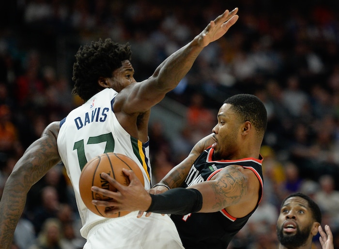 (Francisco Kjolseth  |  The Salt Lake Tribune)  Portland Trail Blazers guard Kent Bazemore (24) makes a pass around Utah Jazz center Ed Davis (17) as the Utah Jazz host the Portland Trailblazers in their NBA basketball game at Vivint Smart Home Arena in Salt Lake City on Wed. Oct. 16, 2019.