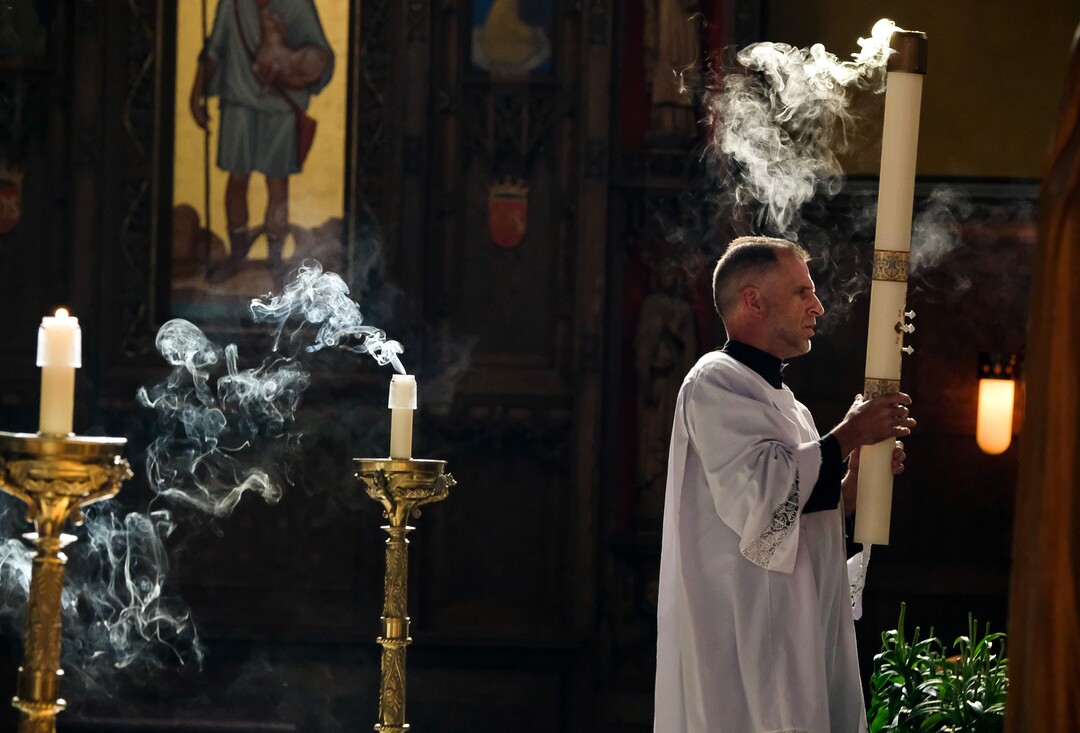 (Francisco Kjolseth  |  The Salt Lake Tribune) Altar assistant Darren Williams blows out the candles following morning mass at Cathedral of the Madeleine in Salt Lake City on Friday, May 8, 2020. Numerous restriction have been implemented in order to battle the coronavirus pandemic as worship services begin to reopen.