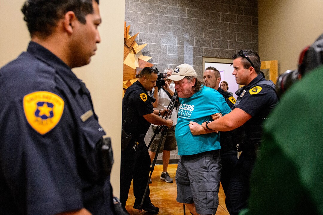 (Trent Nelson  |  The Salt Lake Tribune)  
A man is detained by police after a meeting of an inland port satellite working group was quickly canceled. The meeting was held at a police precinct in Salt Lake City on Wednesday, Aug. 14, 2019.