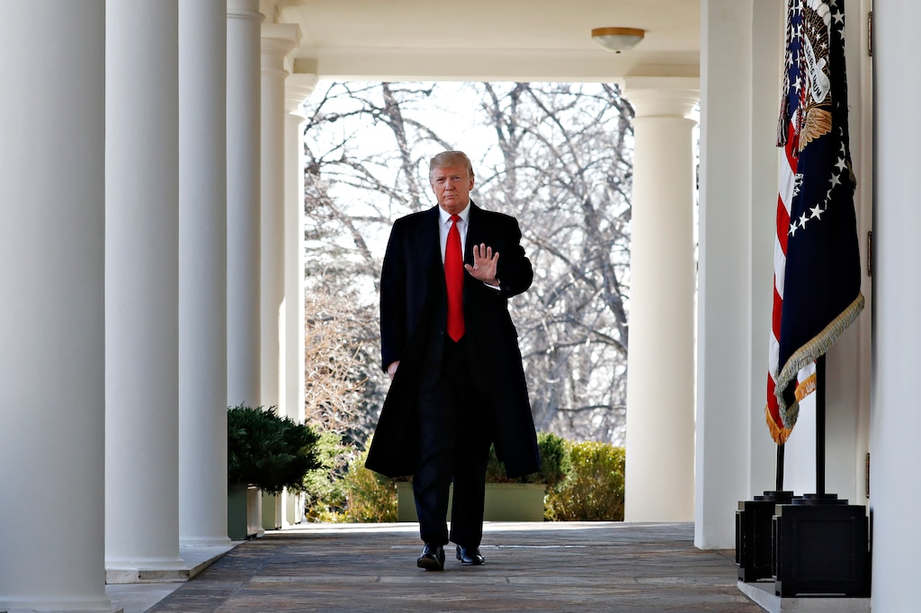(Jacquelyn Martin | The Associated Press) President Donald Trump waves as he walks through the Colonnade from the Oval Office of the White House on arrival to announce a deal to temporarily reopen the government, Friday, Jan. 25, 2019, from the Rose Garden of the White House in Washington.