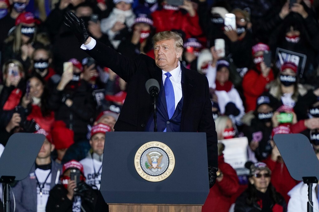 (Morry Gash | AP file photo)  Donald Trump waves after speaking at a campaign rally at the Waukesha County Airport Saturday, in Waukesha, Wis.
